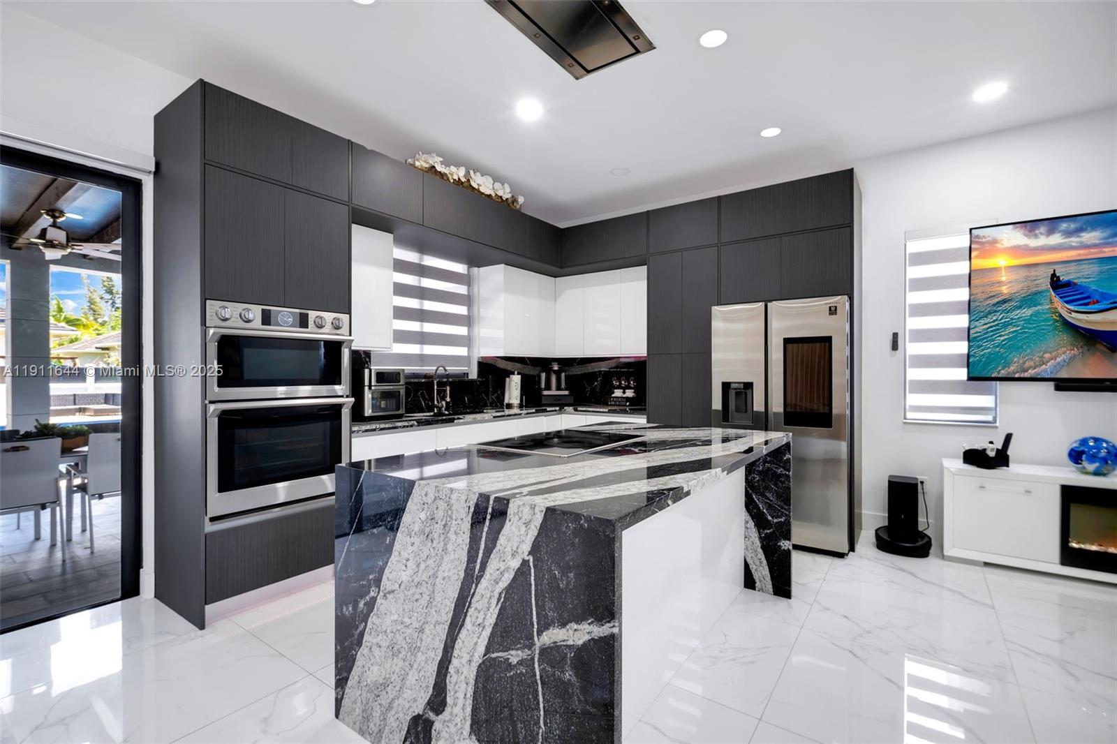 1550 Southwest 89th Court Miami, FL 33174 - Photo 23 of 67 a kitchen with stainless steel appliances a stove sink microwave and cabinets