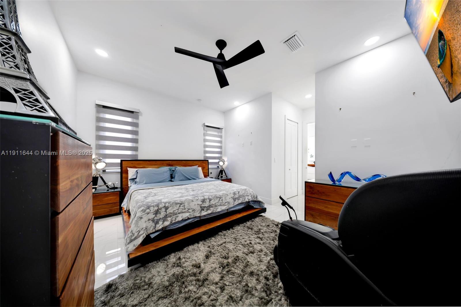 1550 Southwest 89th Court Miami, FL 33174 - Photo 34 of 67 a bedroom with a bed and wooden floor