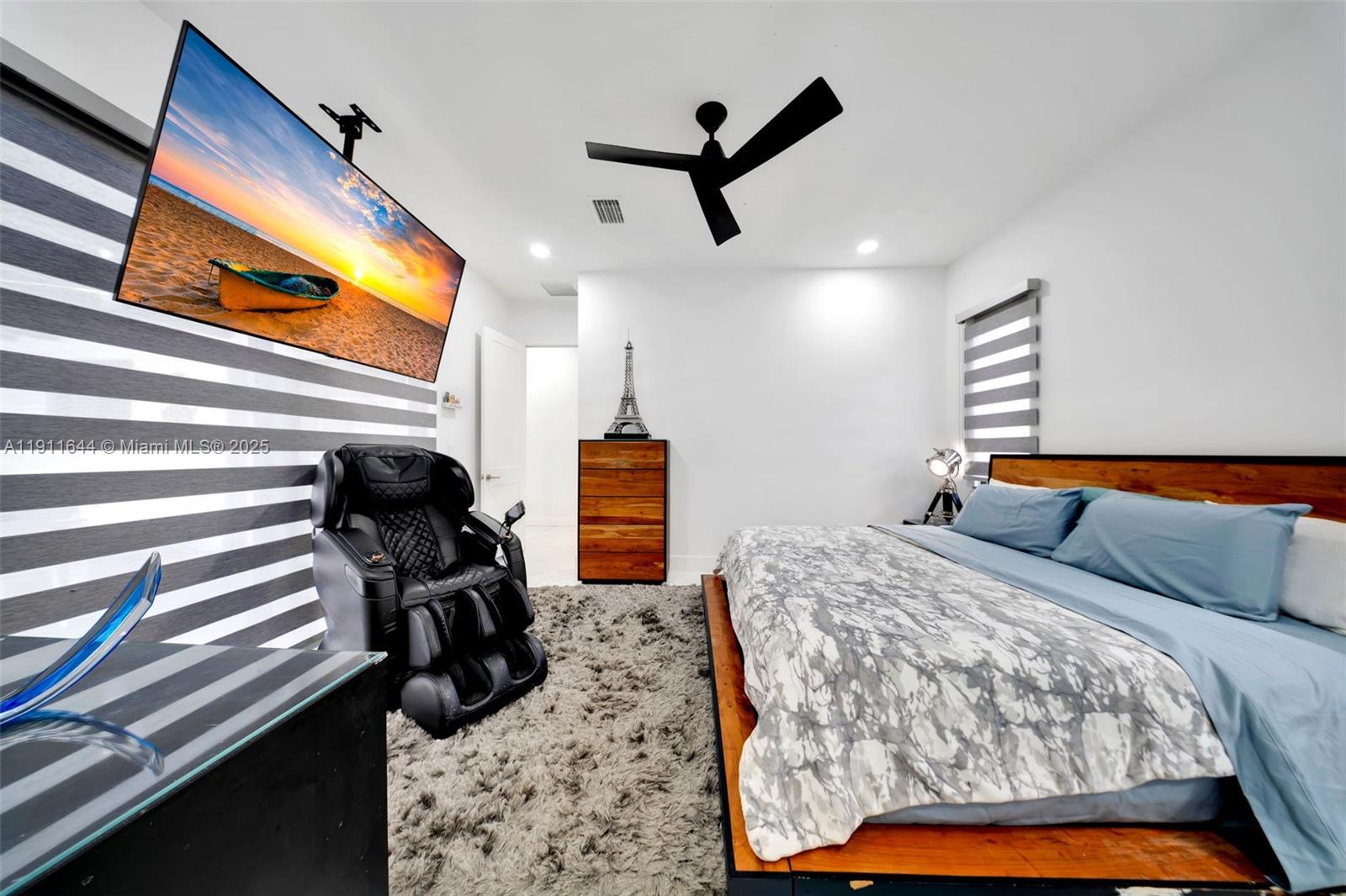 1550 Southwest 89th Court Miami, FL 33174 - Photo 35 of 67 a bedroom with a bed and a flat tv screen on dresser