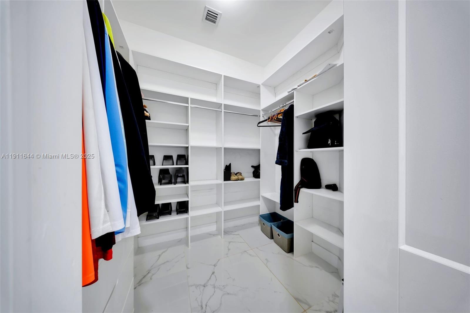 1550 Southwest 89th Court Miami, FL 33174 - Photo 37 of 67 a view of walk in closet with clothes and shoes