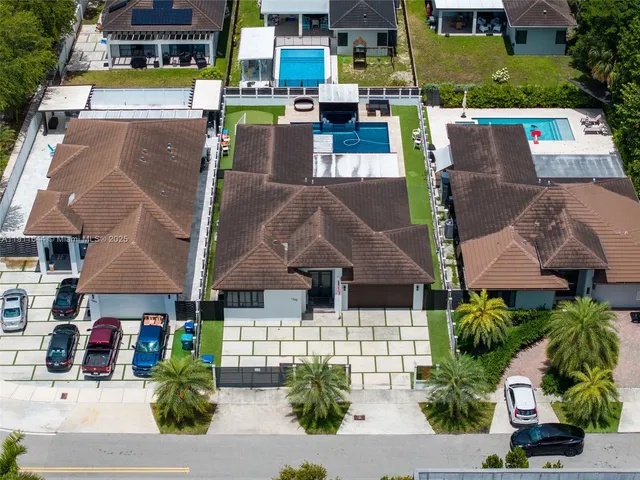 a view of a hallway with dining room and glass windows
