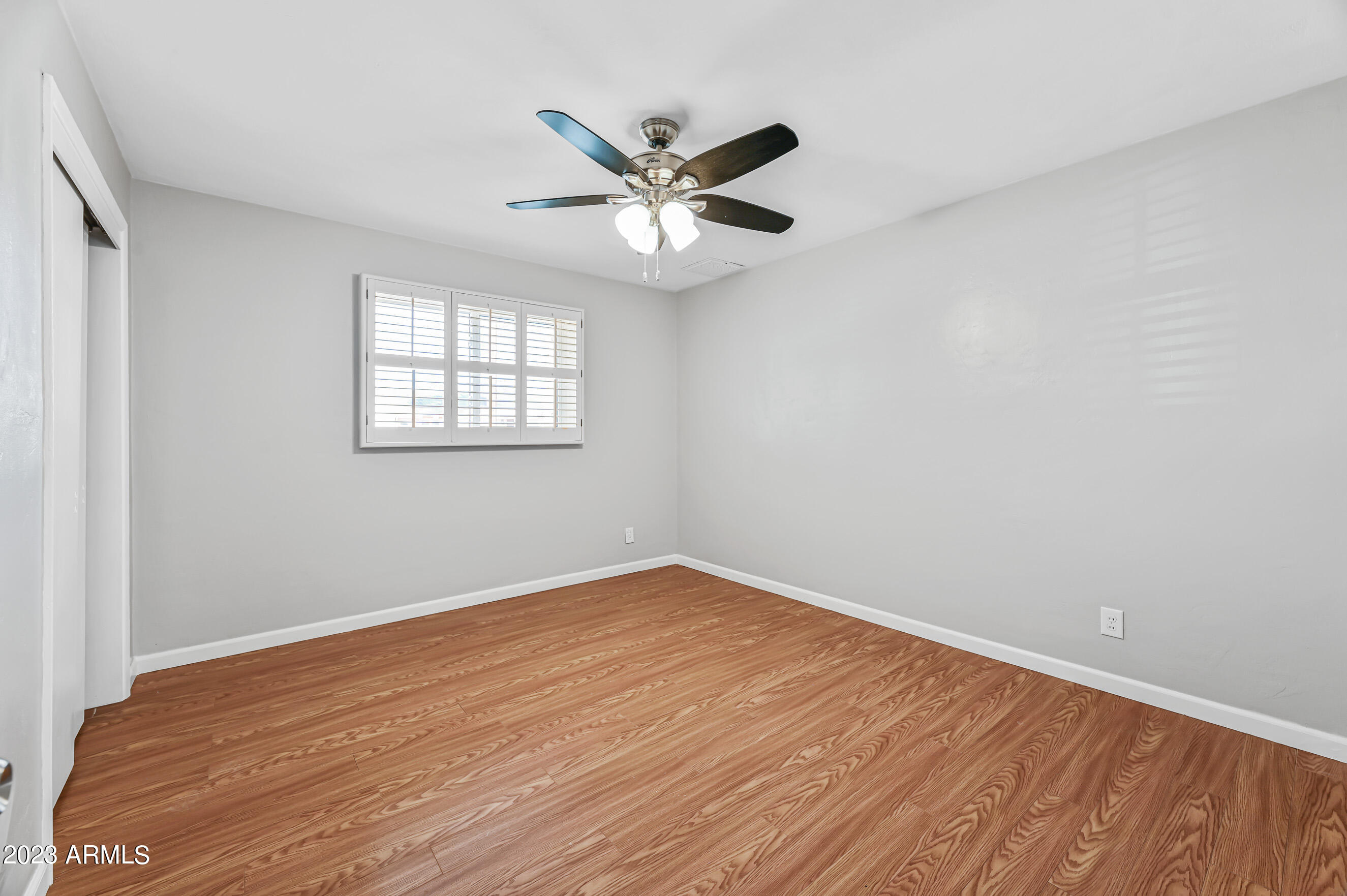 1227 East Las Palmaritas Drive Phoenix, AZ 85020 - Photo 12 of 22 wooden floor in an empty room with a window