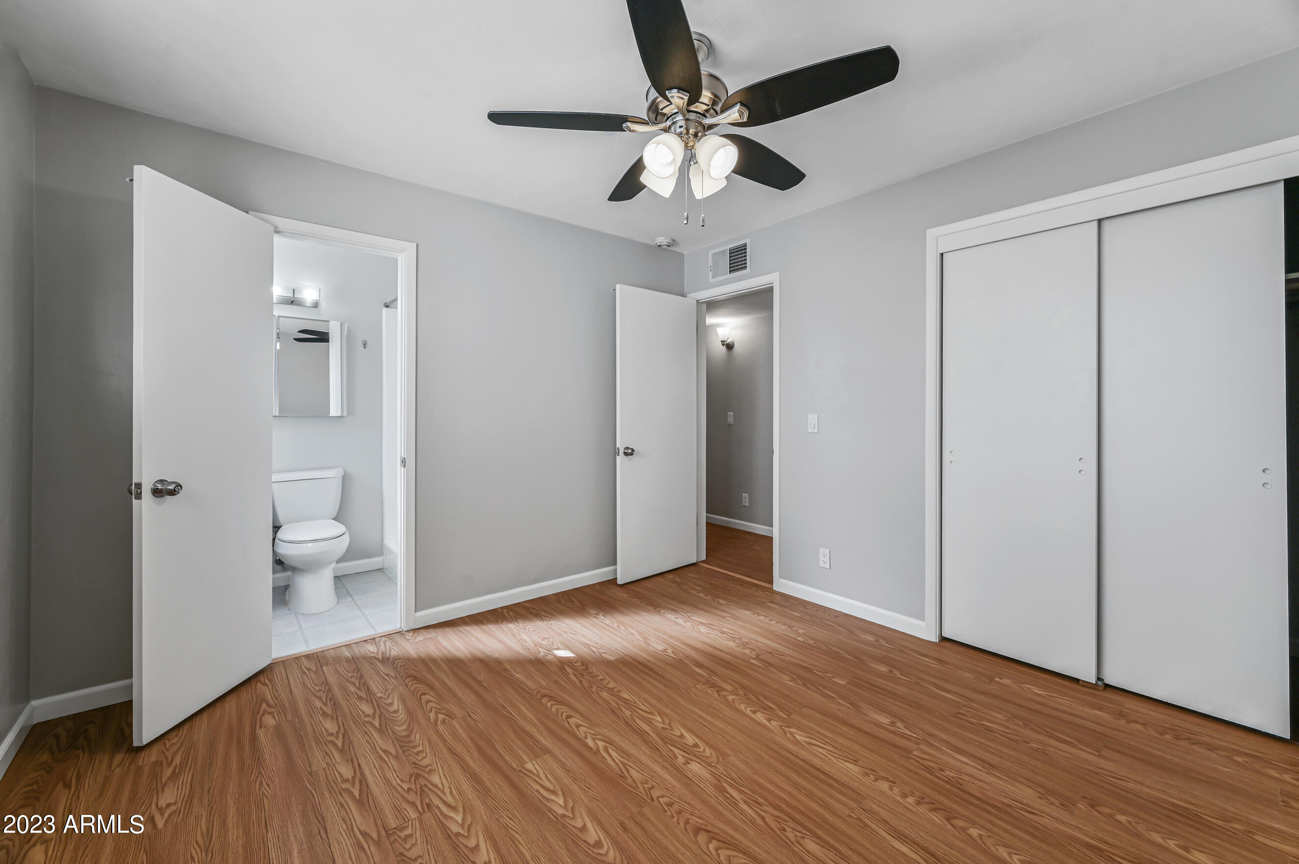 1227 East Las Palmaritas Drive Phoenix, AZ 85020 - Photo 14 of 22 a view of a big room with wooden floor and a chandelier fan