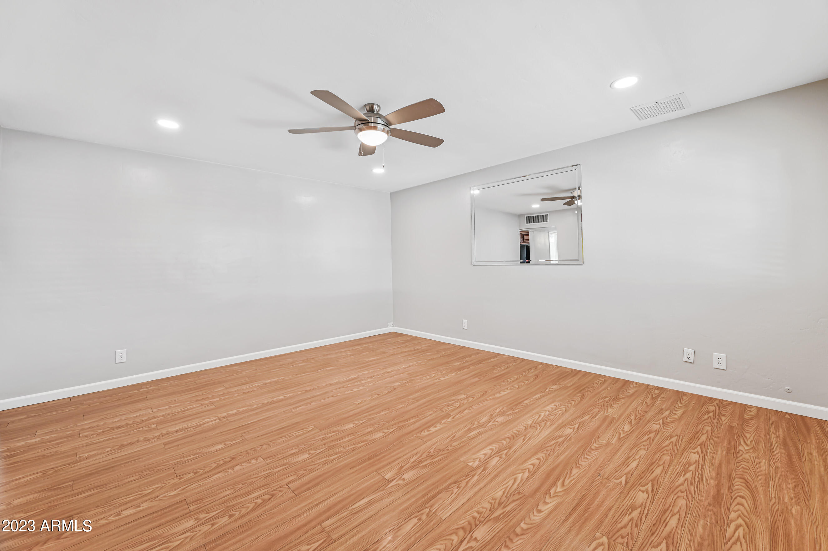 1227 East Las Palmaritas Drive Phoenix, AZ 85020 - Photo 2 of 22 wooden floor in an empty room with a window