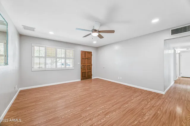 wooden floor in an empty room with a window
