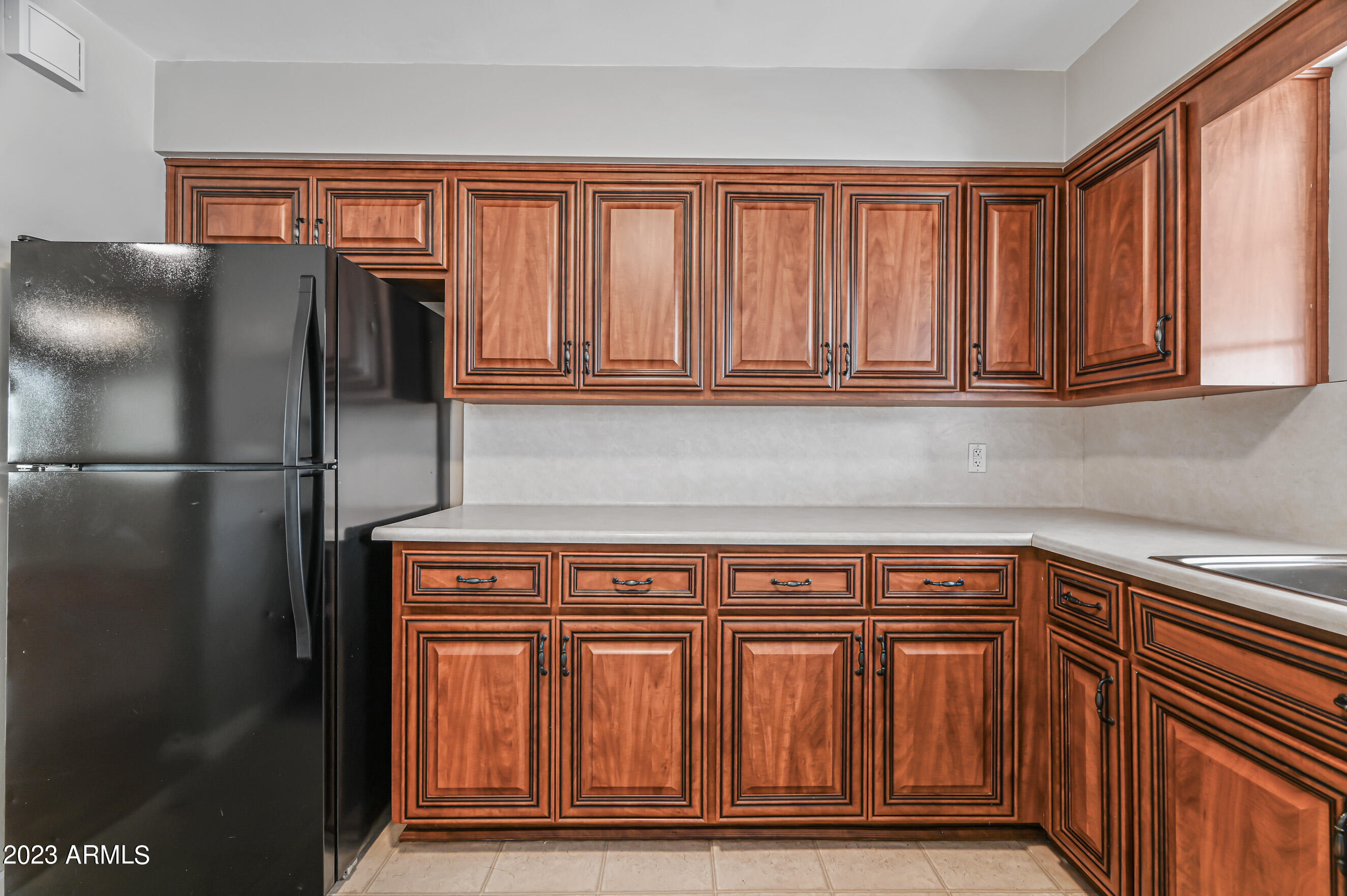 1227 East Las Palmaritas Drive Phoenix, AZ 85020 - Photo 6 of 22 a kitchen with stainless steel appliances granite countertop a refrigerator and cabinets
