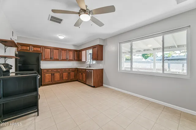 a large white kitchen with a large window