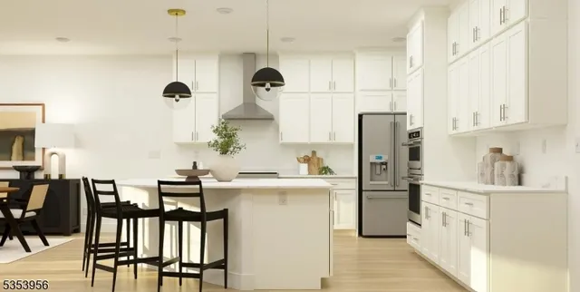 a kitchen with kitchen island a counter top space a sink stainless steel appliances and cabinets