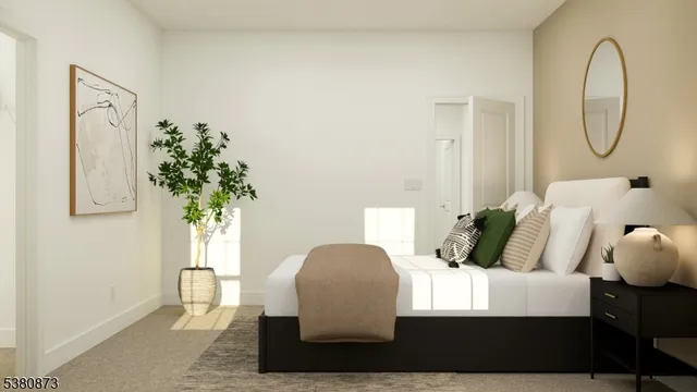 a bedroom with bed and a potted plant