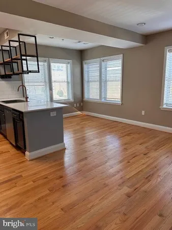 a view of kitchen with granite countertop cabinets and wooden floor