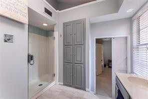 4050 Frankford Road, Unit 908 Dallas, TX 75287 - Photo 11 of 16 Shower enclosure with glass door, recessed lighting, and light gray cabinetry