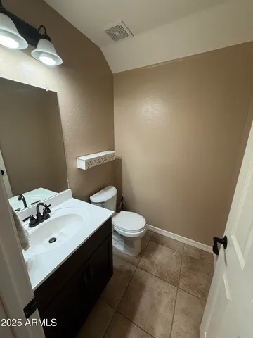 a bathroom with a sink mirror and toilet