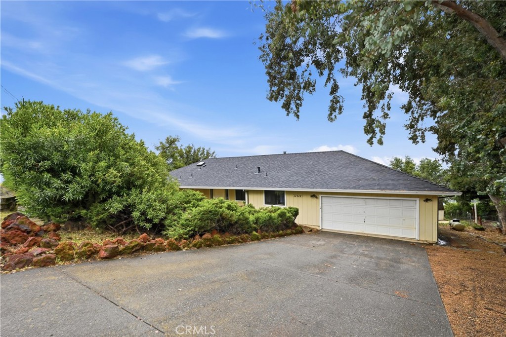 17312 Greenridge Road Hidden Valley Lake, CA 95467 - Photo 1 of 34 a view of a house with a yard and a garage