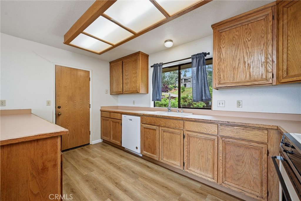 17312 Greenridge Road Hidden Valley Lake, CA 95467 - Photo 11 of 34 a kitchen with granite countertop cabinets stainless steel appliances a sink and a window