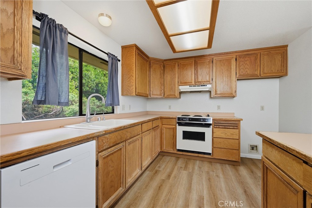 17312 Greenridge Road Hidden Valley Lake, CA 95467 - Photo 12 of 34 a kitchen with stainless steel appliances granite countertop a stove a sink and a microwave