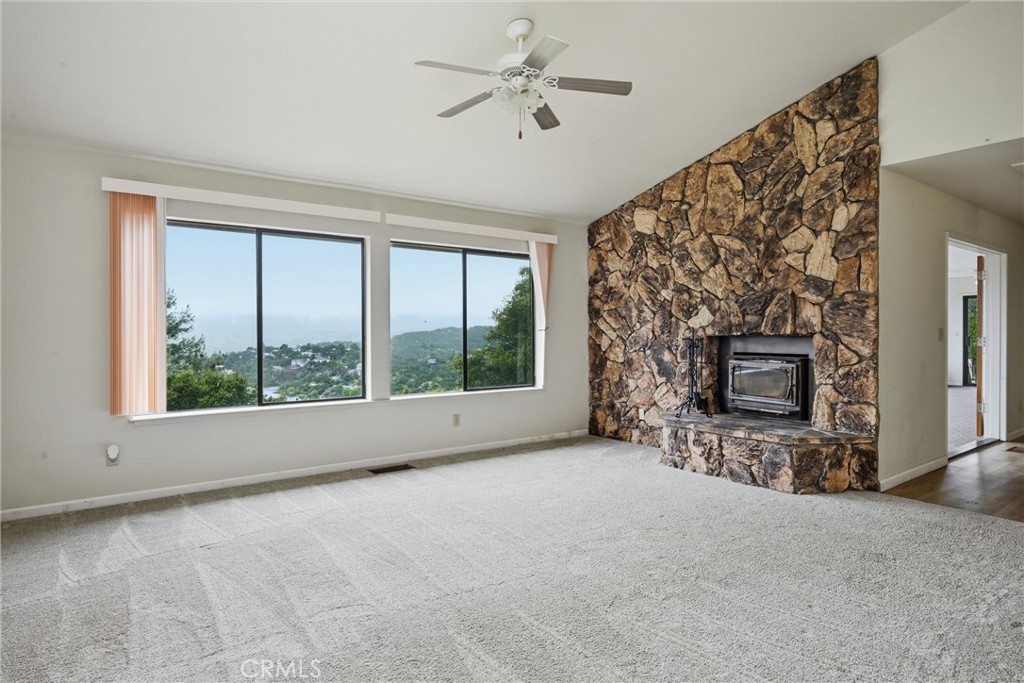 17312 Greenridge Road Hidden Valley Lake, CA 95467 - Photo 4 of 34 a view of an empty room with a fireplace and a window