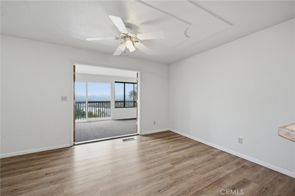 17312 Greenridge Road Hidden Valley Lake, CA 95467 - Photo 7 of 34 an empty room with wooden floor and windows