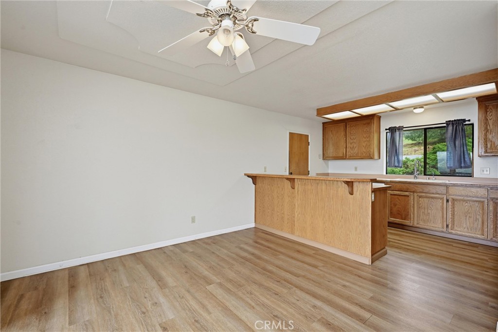 17312 Greenridge Road Hidden Valley Lake, CA 95467 - Photo 8 of 34 a view of a kitchen with a sink a kitchen island with wooden floor