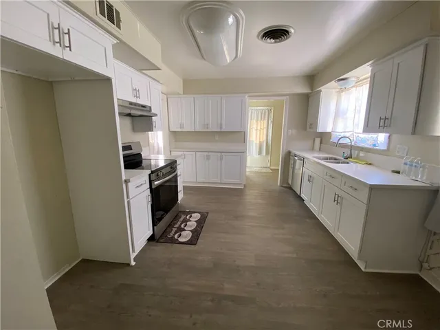 a kitchen with a sink cabinets and window