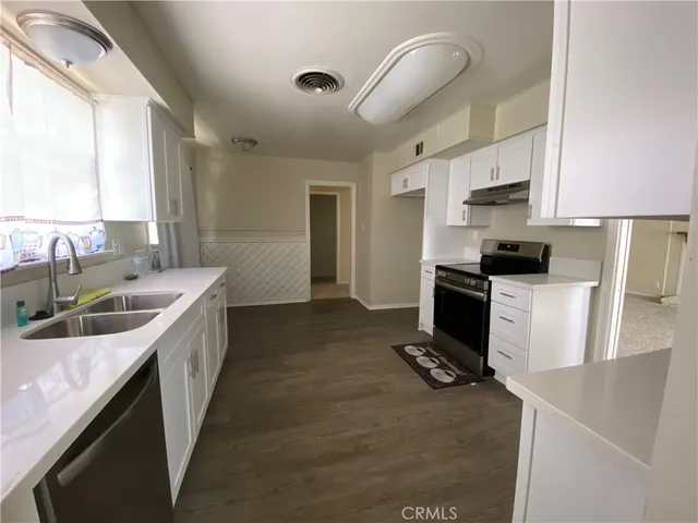a kitchen with a sink stove and refrigerator