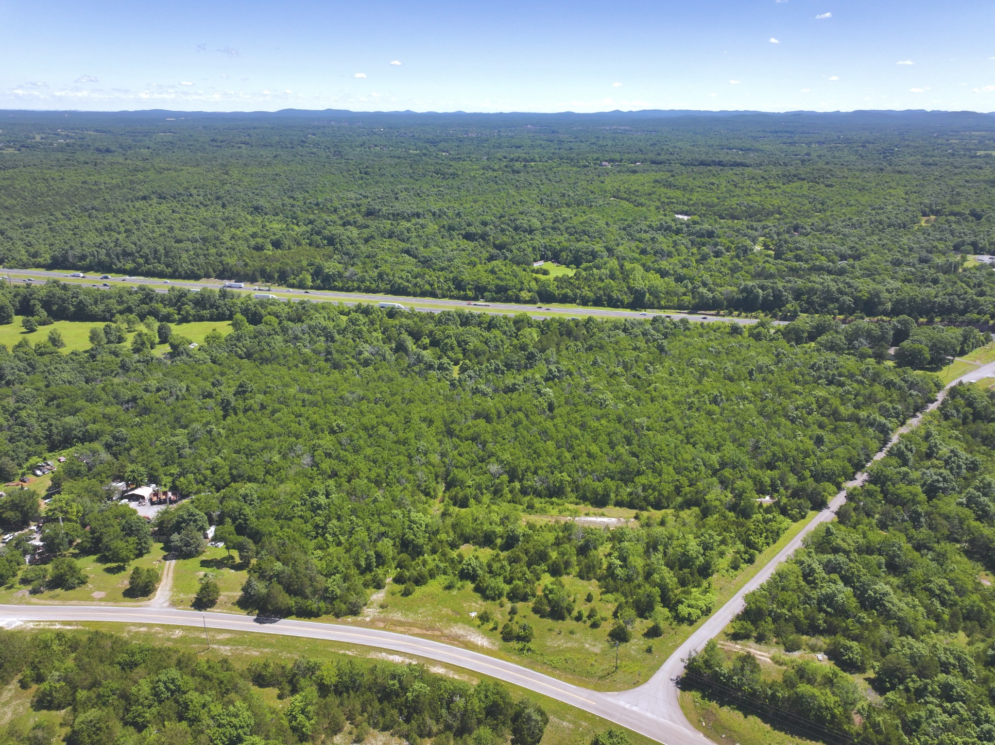 0 Buckeye Bottom Road East Murfreesboro, TN 37129 - Photo 4 of 9 a view of a lush green hillside next to a yard