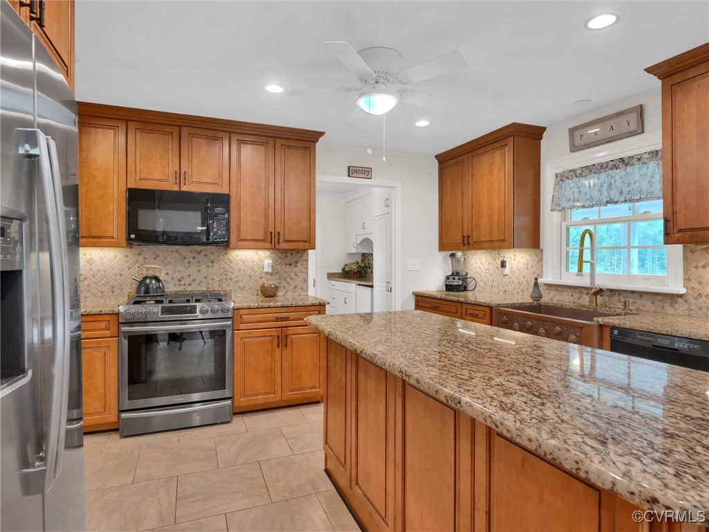 727 Eanes Road Kenbridge, VA 23944 - Photo 14 of 50 a kitchen with stainless steel appliances granite countertop a stove a sink and a microwave