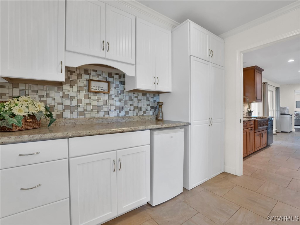 727 Eanes Road Kenbridge, VA 23944 - Photo 18 of 50 a kitchen with white cabinets and white appliances