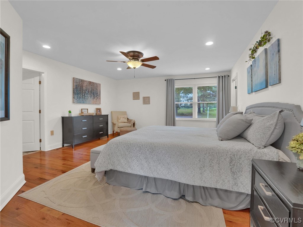 727 Eanes Road Kenbridge, VA 23944 - Photo 25 of 50 a bedroom with a large bed and a chandelier
