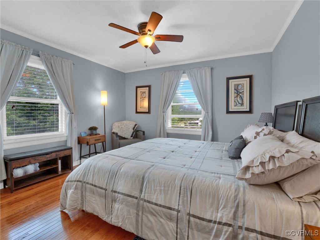 727 Eanes Road Kenbridge, VA 23944 - Photo 34 of 50 a bedroom with a large bed a chandelier and a window