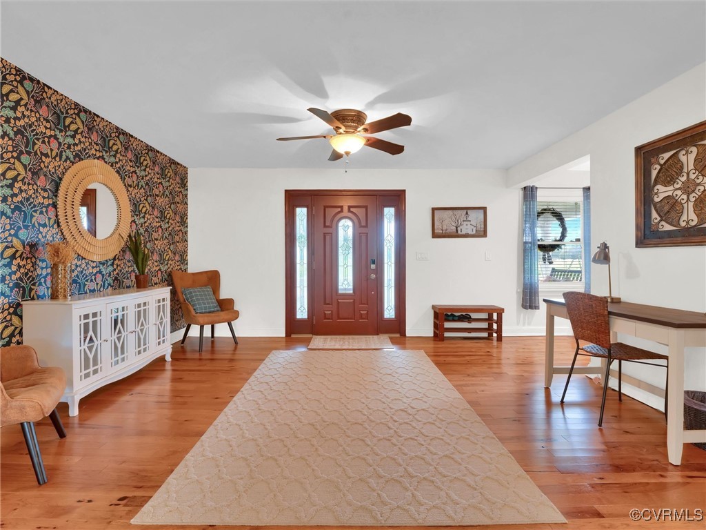 727 Eanes Road Kenbridge, VA 23944 - Photo 8 of 50 a living room with furniture a rug and a chandelier