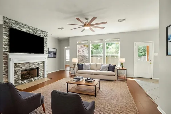 a living room with furniture a fireplace and a flat screen tv