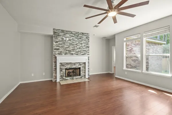 a large white kitchen with a window and cabinets