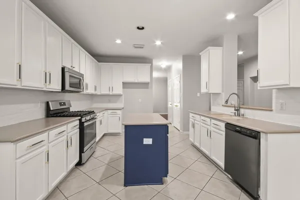 a kitchen with cabinets and appliances