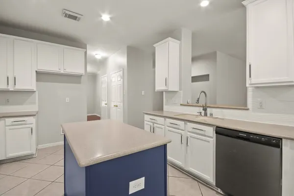 a kitchen with cabinets appliances a sink and a counter top space