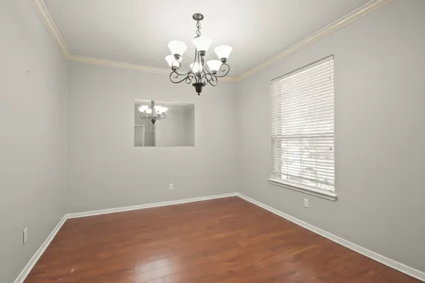 a view of a room with windows and chandelier