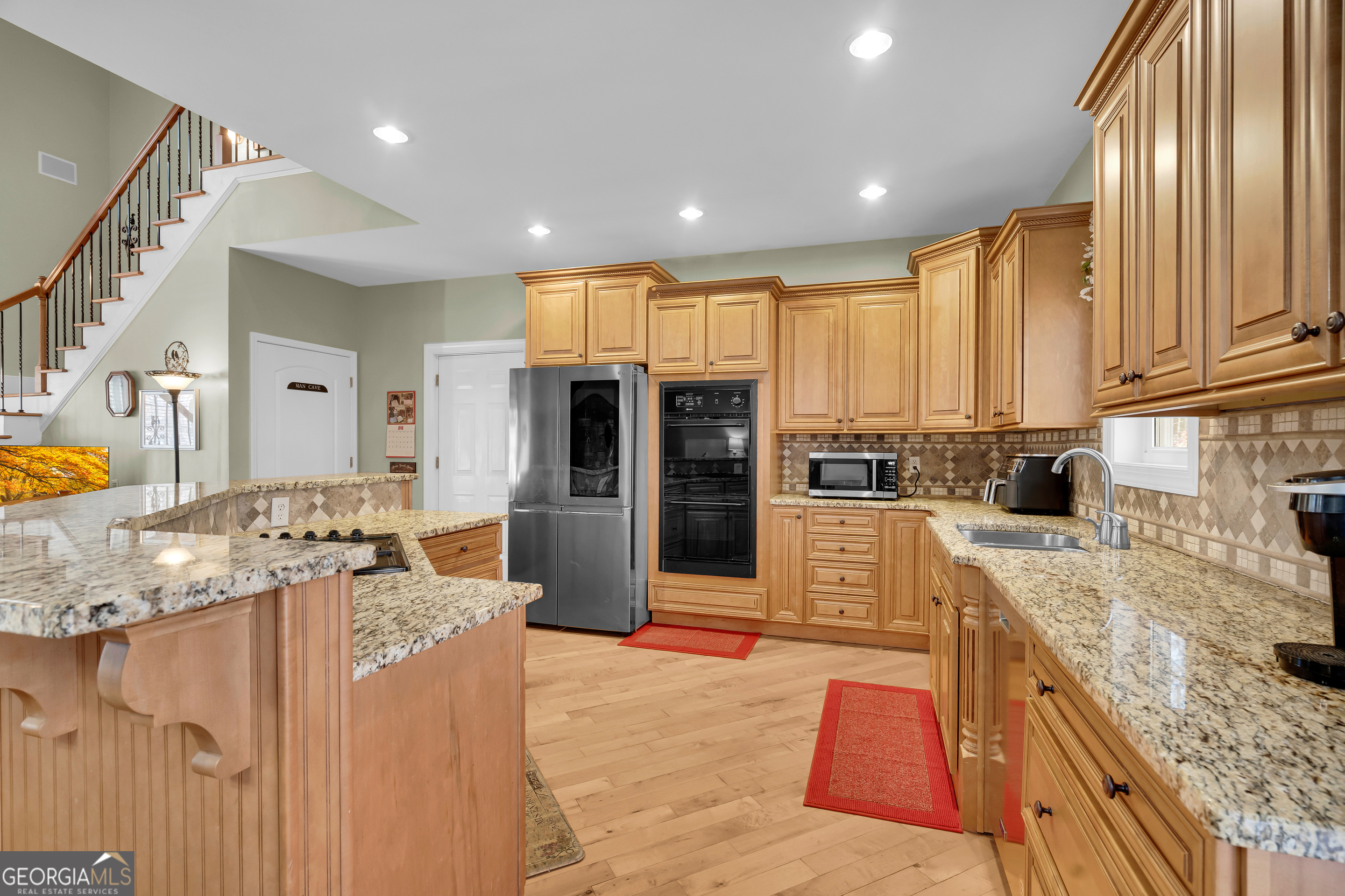 141 Shadow Walk Drive Mount Airy, GA 30563 - Photo 15 of 65 a large kitchen with stainless steel appliances granite countertop a large counter top and a stove