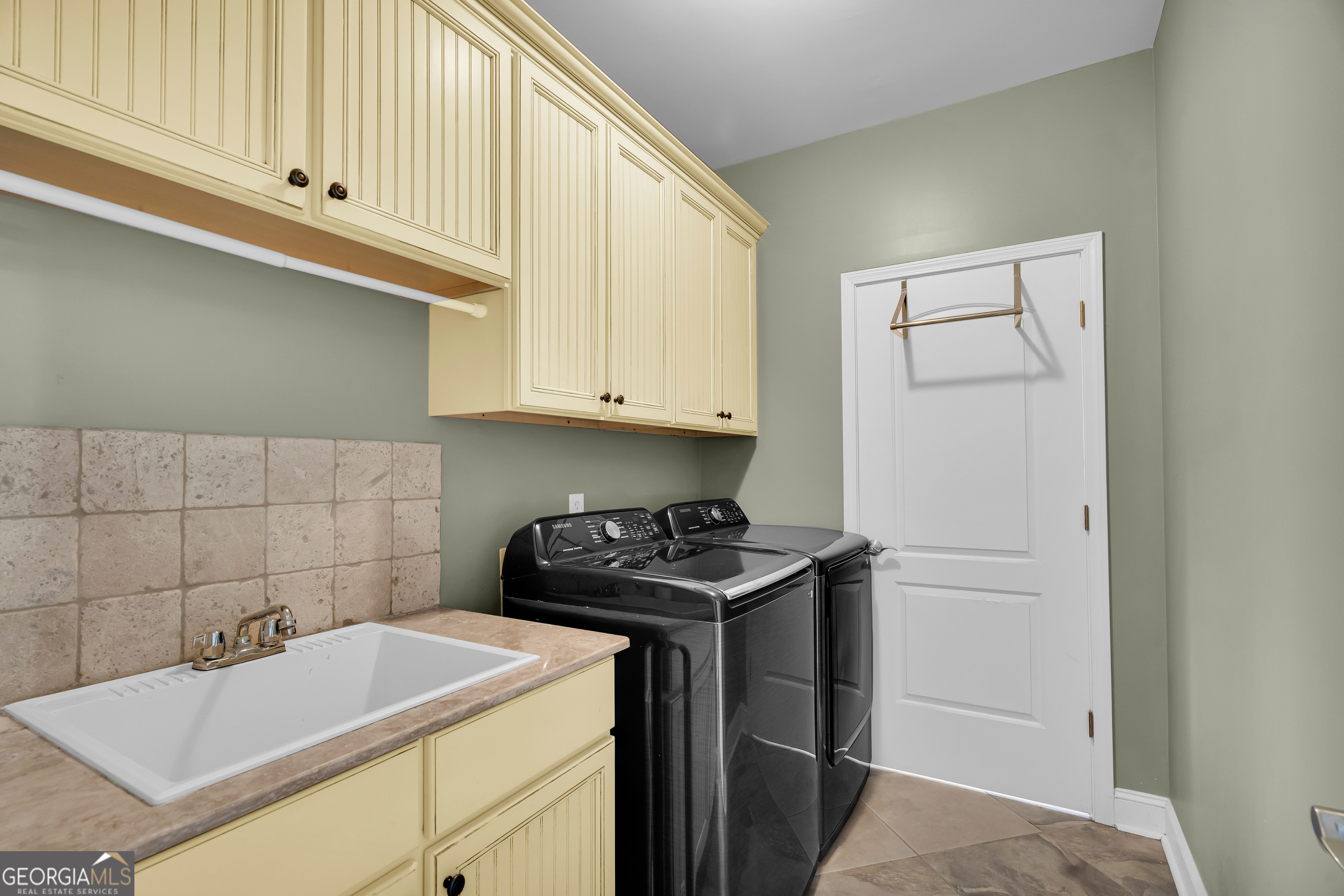 141 Shadow Walk Drive Mount Airy, GA 30563 - Photo 18 of 65 a kitchen with a sink cabinets and a stove top oven