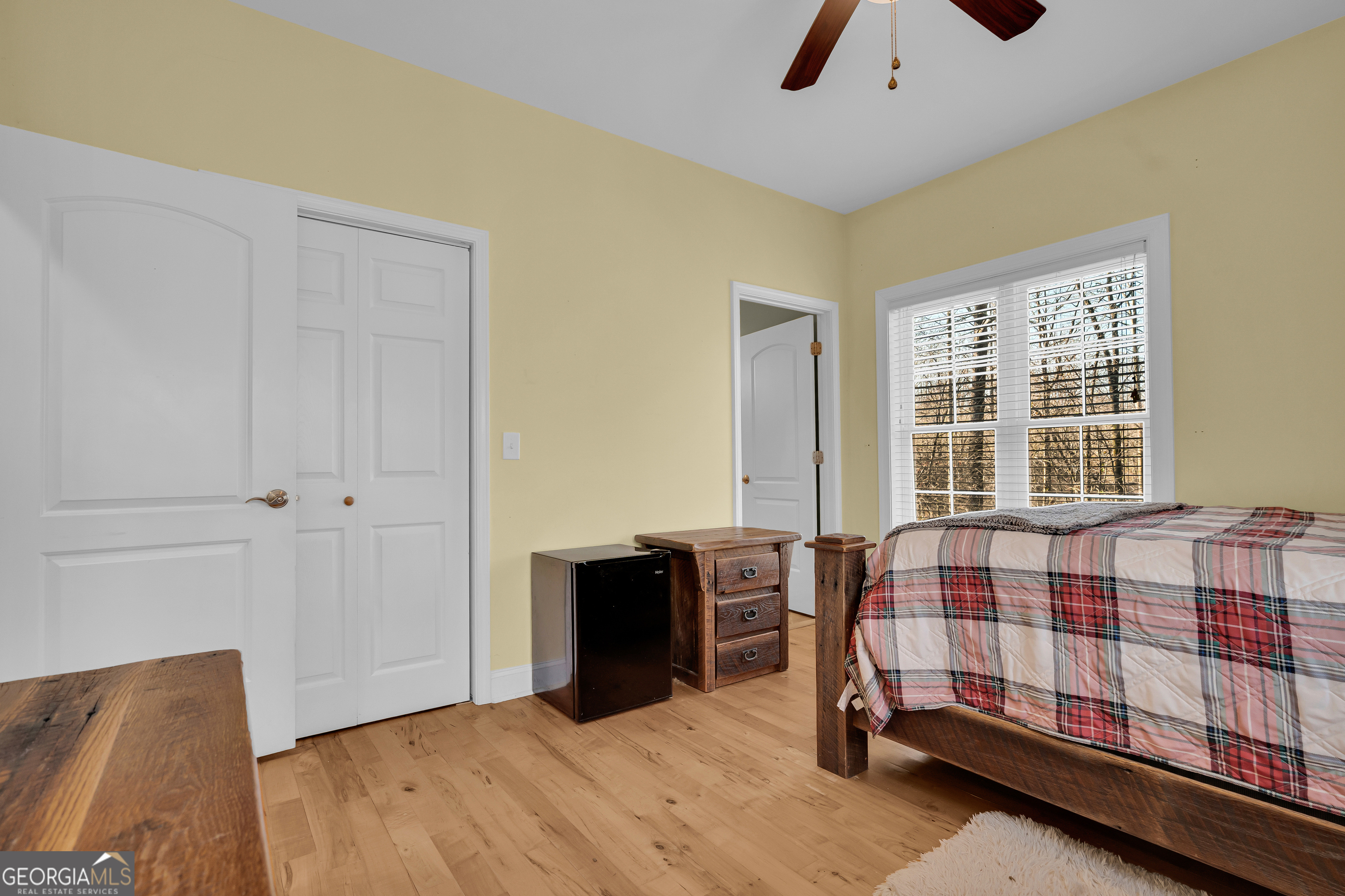 141 Shadow Walk Drive Mount Airy, GA 30563 - Photo 20 of 65 a bedroom with a bed and wooden floor