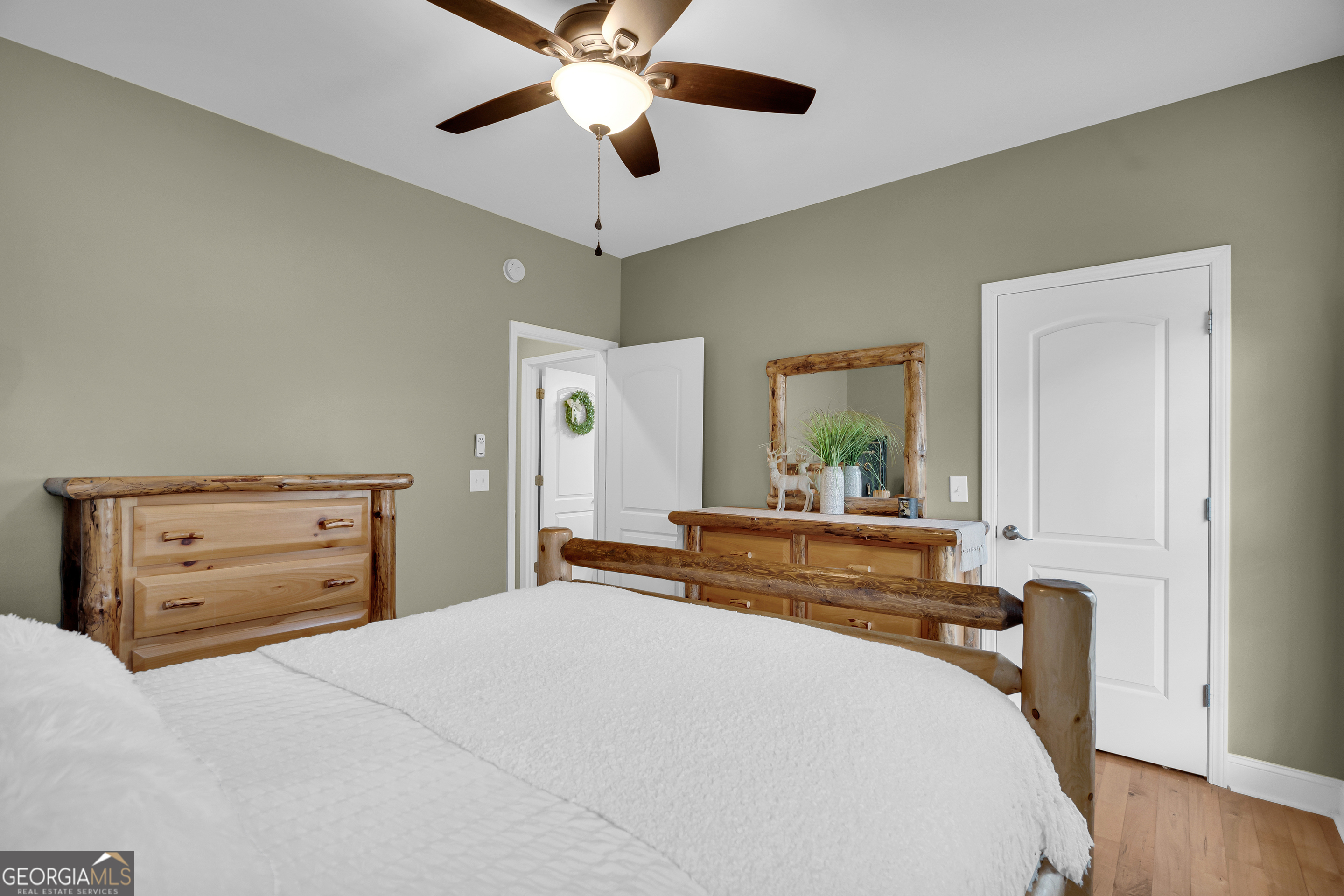 141 Shadow Walk Drive Mount Airy, GA 30563 - Photo 23 of 65 a bedroom with a bed and wooden floor