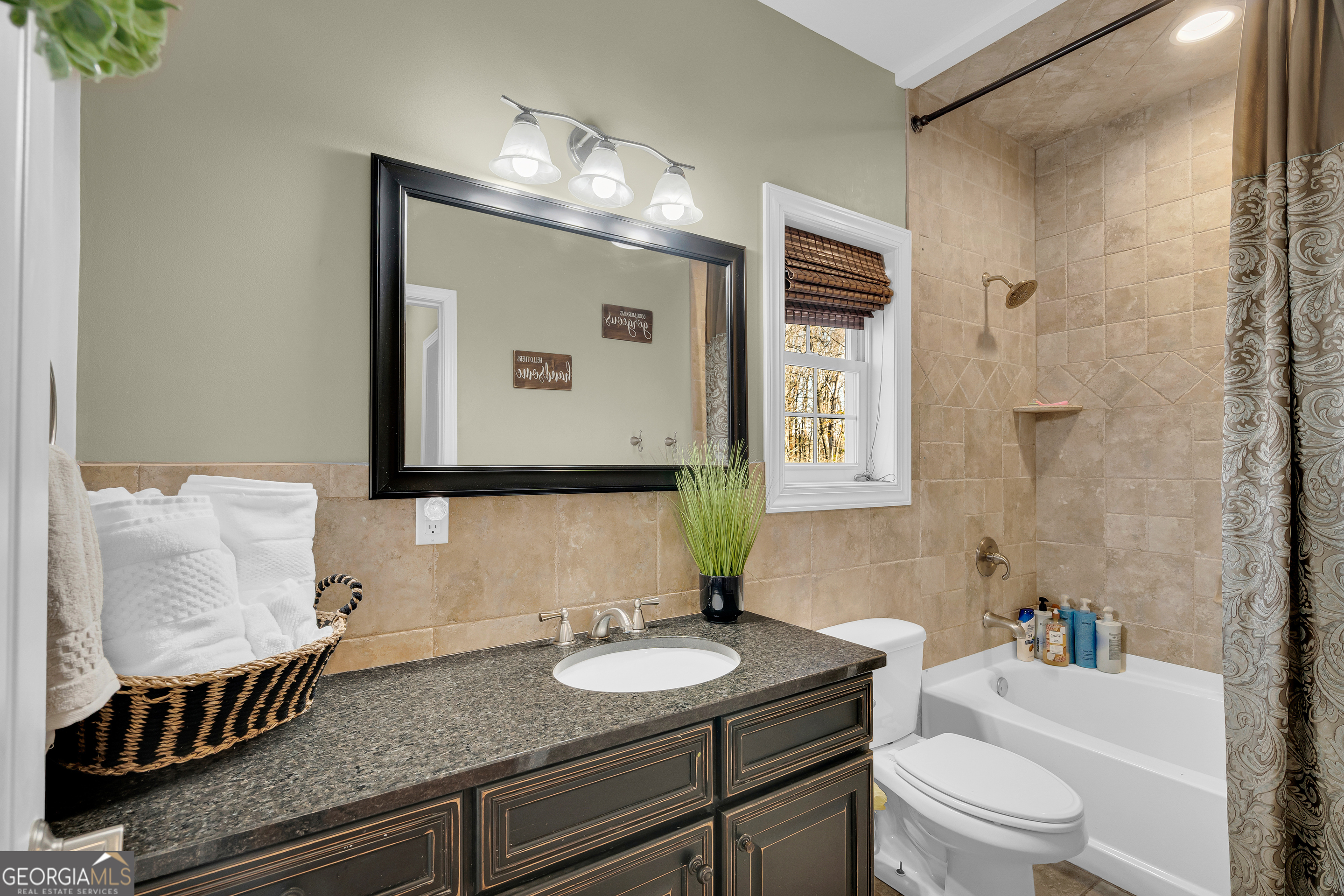 141 Shadow Walk Drive Mount Airy, GA 30563 - Photo 24 of 65 a bathroom with a granite countertop sink and a mirror
