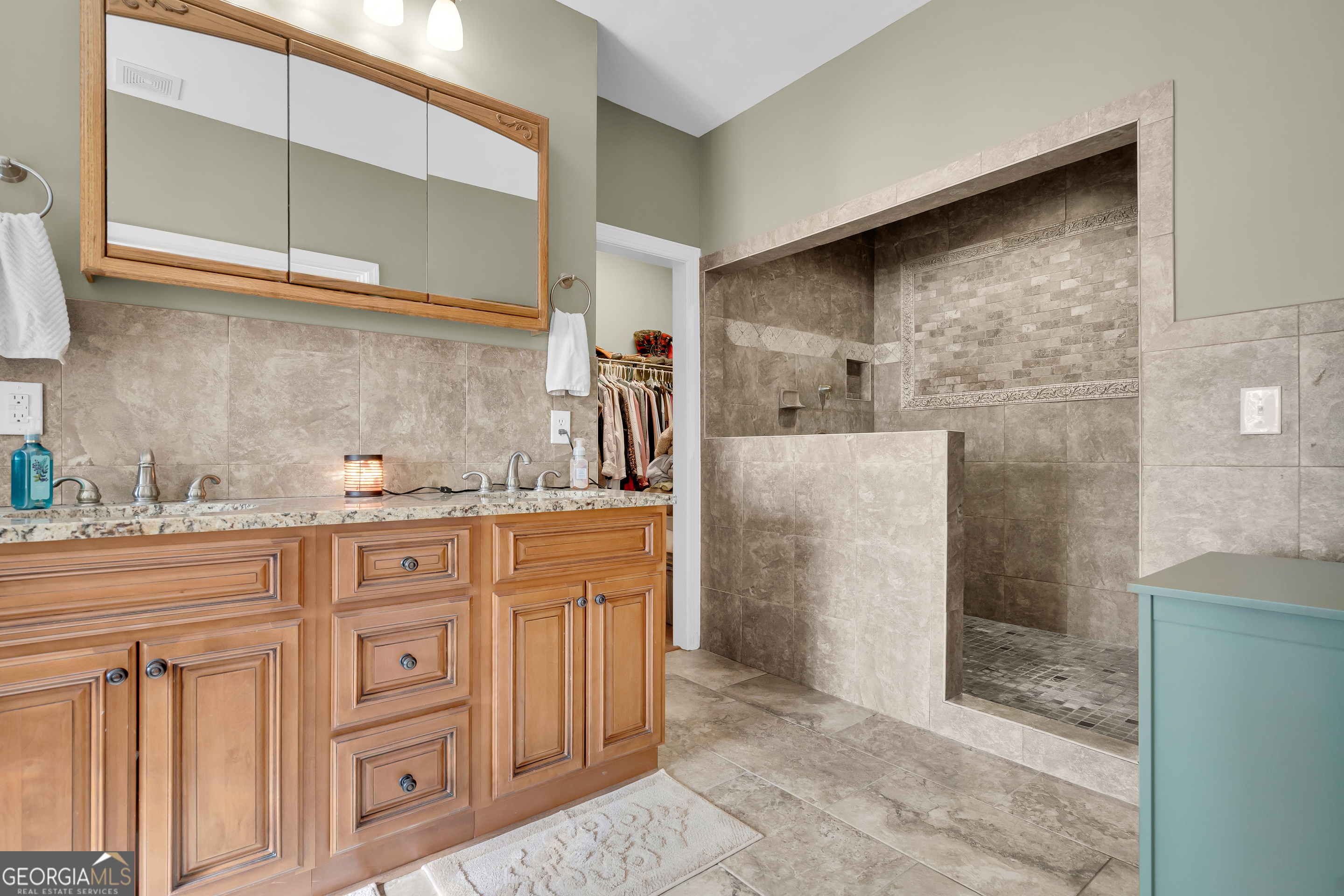 141 Shadow Walk Drive Mount Airy, GA 30563 - Photo 34 of 65 a bathroom with granite countertop a sink and a shower