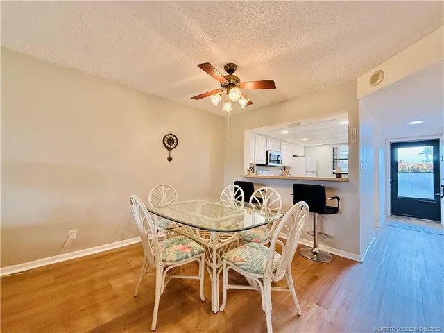 a living room with furniture a flat screen tv and a large window