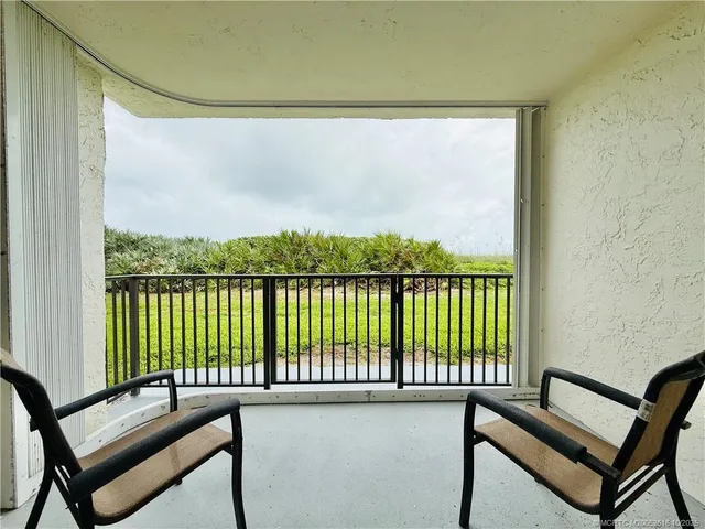 a view of a balcony with furniture