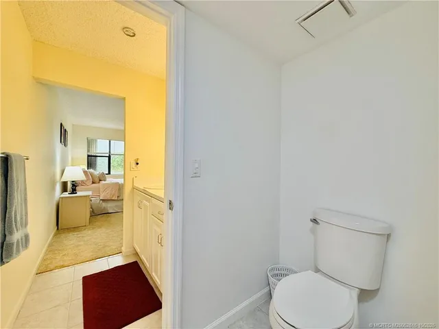 a bathroom with a sink a toilet and mirror