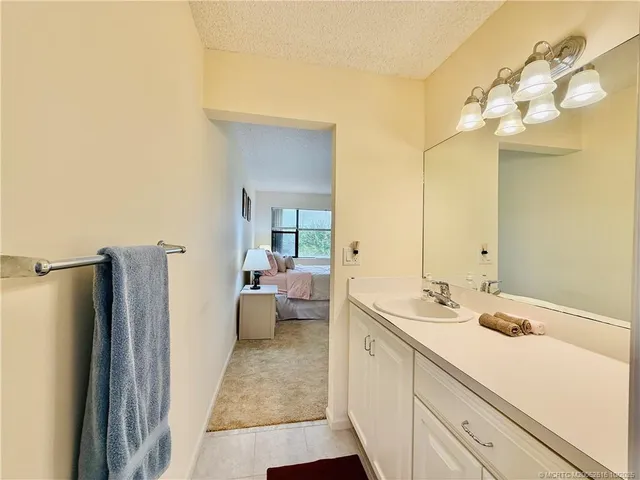 a bedroom with two beds and a chandelier