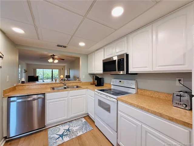 a view of a dining room with furniture and a chandelier