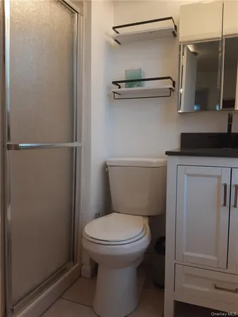 a bathroom with a toilet and a shower