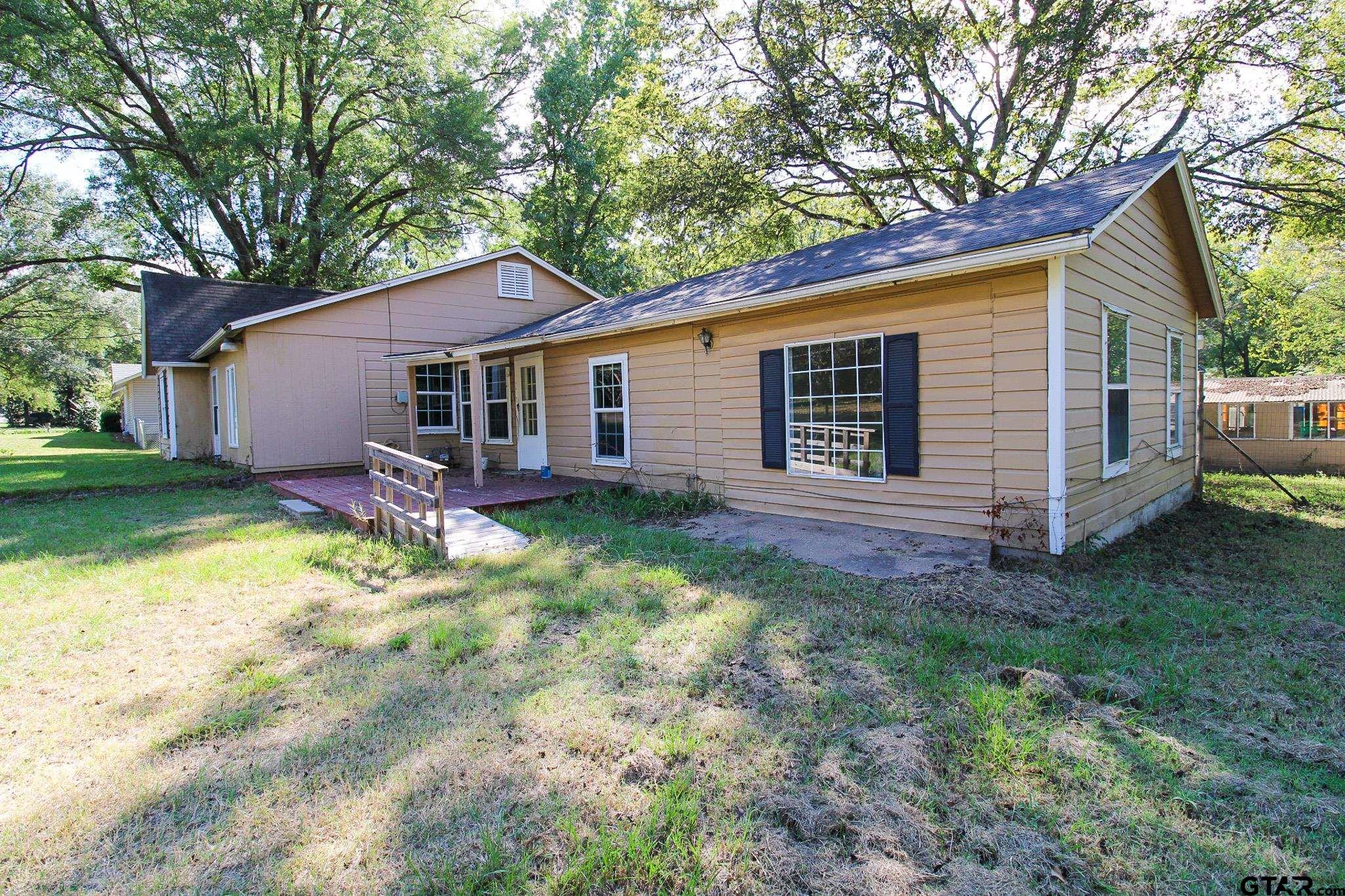 407 Pace Street Naples, TX 75568 - Photo 3 of 31 a view of a house with a yard