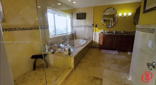 a bathroom with a sink mirror and vanity