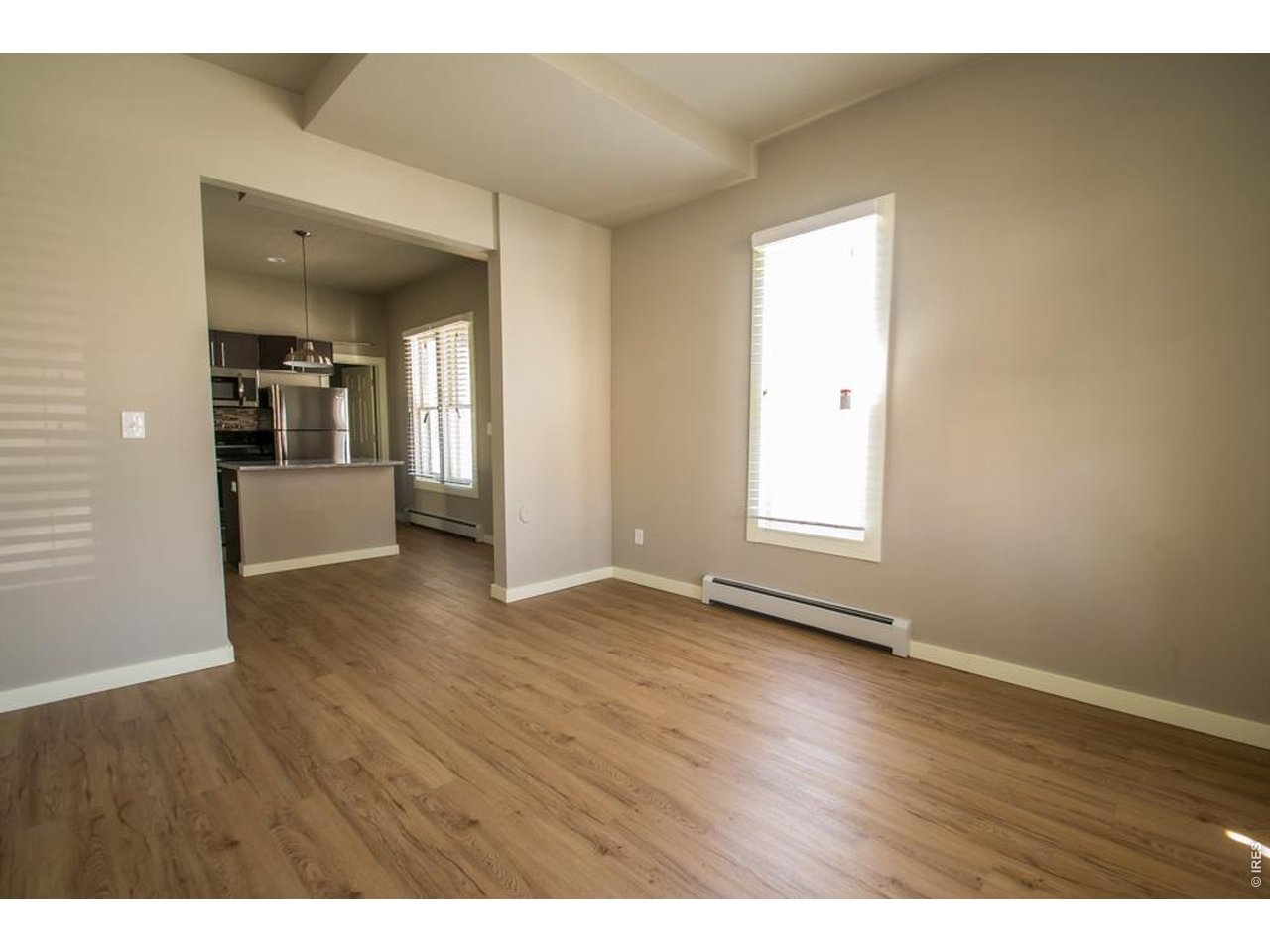 1806 17th Street Boulder, CO 80302 - Photo 11 of 45 a view of an empty room with wooden floor and a window